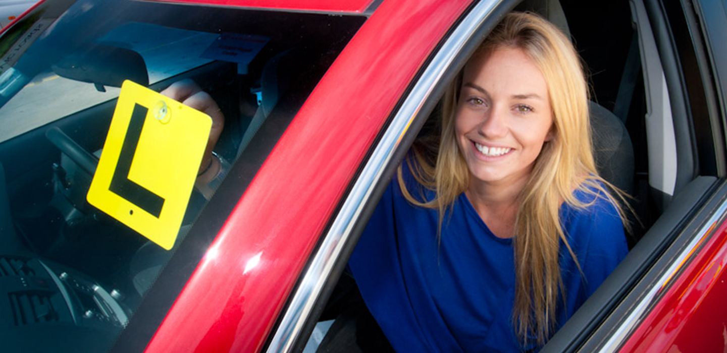 Learner sitting in car with L plate