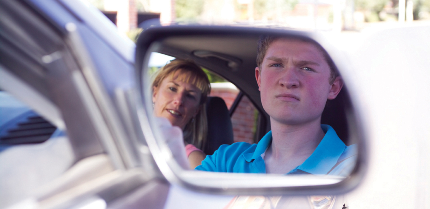 Learner staring in the side view mirror